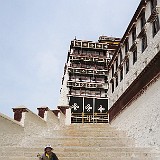 Pilgrim at Potala Palace  Lhasa is full of pilgrims, visiting the sacred places and doing the Kora around them. This pilgrim takes a rest when ascending the steep stairs up to the Potala palace.